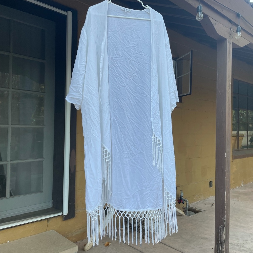 White duster with fringe.